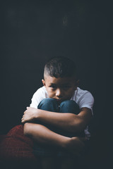 scared and alone, young Asian child who is at high risk of being bullied, trafficked and abused