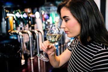 Attractive woman smelling white wine