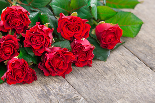 red roses on wooden board