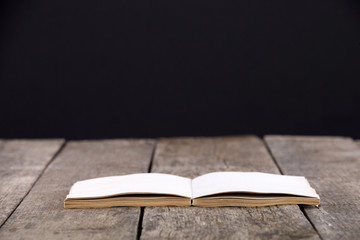 Vintage book, open, on old wooden table