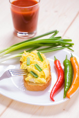 American style scrambled eggs on toast with
a glass of juice

