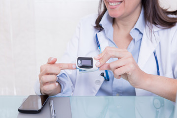 Medic showing finger pulse oximeter