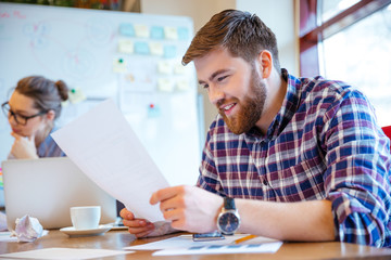 Businessman reading paper in office