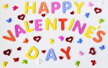 Text of colorful letters Happy Valentines day with multicolored small butterflies and red hearts