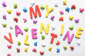 Text of colorful letters My Valentine on the white background with multicolored small butterflies