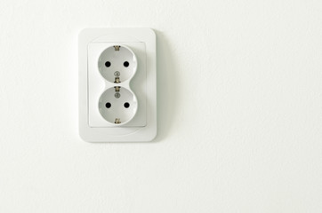 European white electrical outlet socket on white wall