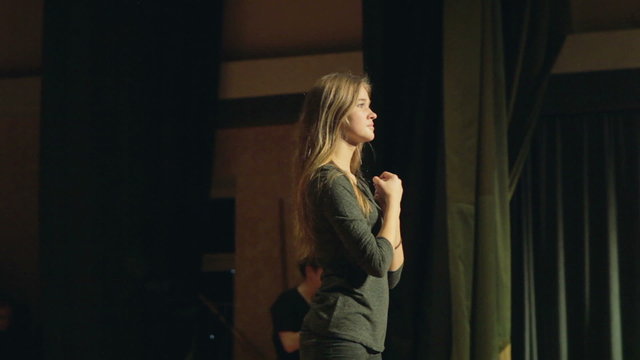 girl plays a role on the stage