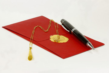 Golden necklace and a red envelope