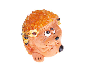 Toy hedgehog made of amber on a white background © enskanto