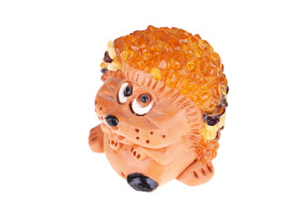Toy hedgehog made of amber on a white background © enskanto