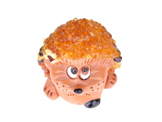 Toy hedgehog made of amber on a white background