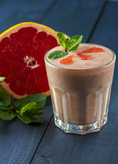 Glass of homemade smoothie with grapefruit, banana and mint leaves . Conception of healthy food.  Nonalcoholic drinks.