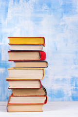 Composition with old vintage colorful hardback books, diary on w