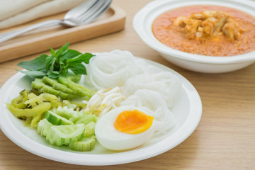 Boiled egg with rice noodles on plate and curry crab, Thai food