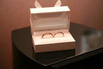 gold wedding rings lie in a box