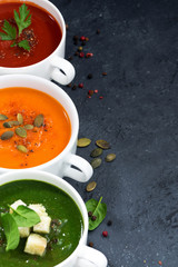 assortment of vegetable cream soup on and dark background