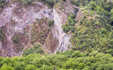 Mountain landscape waterfall flows down the cliff. The landscape in Armenia (Tatev). The canyon next to the cable car 