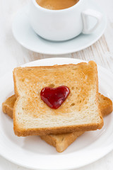 toast with jam in the shape of a heart and coffee, closeup