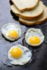 Fried eggs on black background