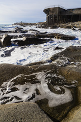 Landscape of a cliff with an old and ruined building in the background
