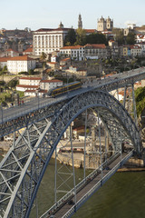 Fototapeta na wymiar Dom Luis I Bridge. Built in 1887, the Dom Luis I Bridge is a two tiered bridge that spans the Douro River that runs through Porto, Portugal. The city is built down the steep river banks.