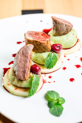 Beautiful juicy grilled meat with garnish on a wooden table