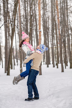 Winter fun couple playful together during winter holidays vacation
