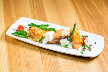 Salmon Steak with Grilled Vegetables, White Sauce and Lime