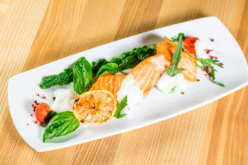 Salmon Steak with Grilled Vegetables, White Sauce and Lime