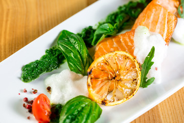 Salmon Steak with Grilled Vegetables, White Sauce and Lime