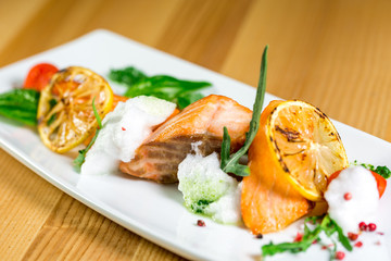 Salmon Steak with Grilled Vegetables, White Sauce and Lime
