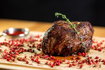 Beautiful juicy well done a piece of meat with sauce on a wooden table