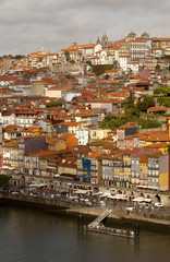 Porto runs down a Steep River Bank. The river Douro has cut a deep river path through the landscape where Porto the historical town has been built. Porto cascades down these steep river banks.
