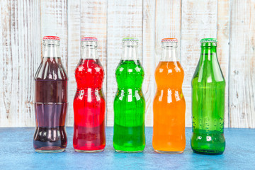 variety of soda bottle on the wooden background