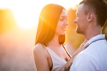 Couple in love - Beginning of a Love Story. A man and a girl with a tattoo on the nature