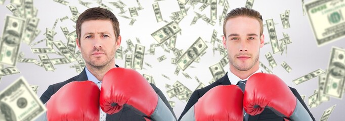 Composite image of businessman with boxing gloves