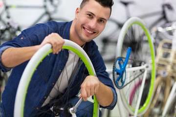 Fototapeta na wymiar Man working in bicycle repair shop 