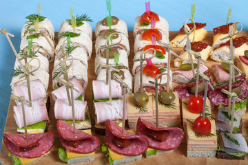 Different kinds of snacks canape on skewers