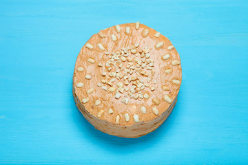 Homemade peanut cake on wooden background. Toned