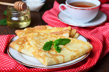 Delicious Pancakes with honey on plate 