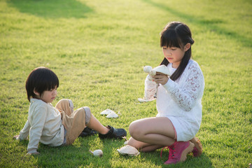 asian children picking mushroom in the park