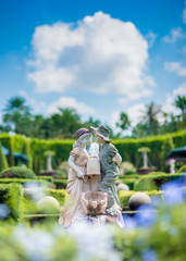 puppy love, Statue of a boy kiss a girl in the garden.