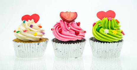 colorful cupcakes with beautiful decoration over white backgroun