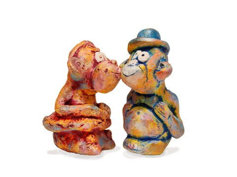 monkeys  from clay pottery kissing. Love concept.  isolated on w