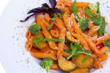 Red penne pasta with tomato sauce and vegetables