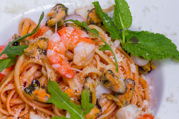 Pasta with seafood and parmesan cheese, closeup