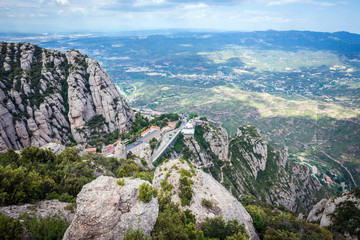 Fototapeta premium Aerial view on Santa Maria de Montserrat Abbey in Montserrat mountains, Spain