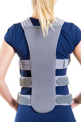 Woman Wearing Supportive Back Brace in Studio.