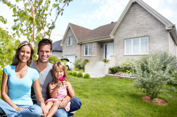 Happy family near new house.