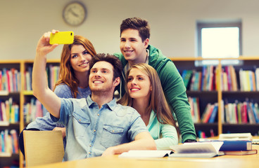 students with smartphone taking selfie in library